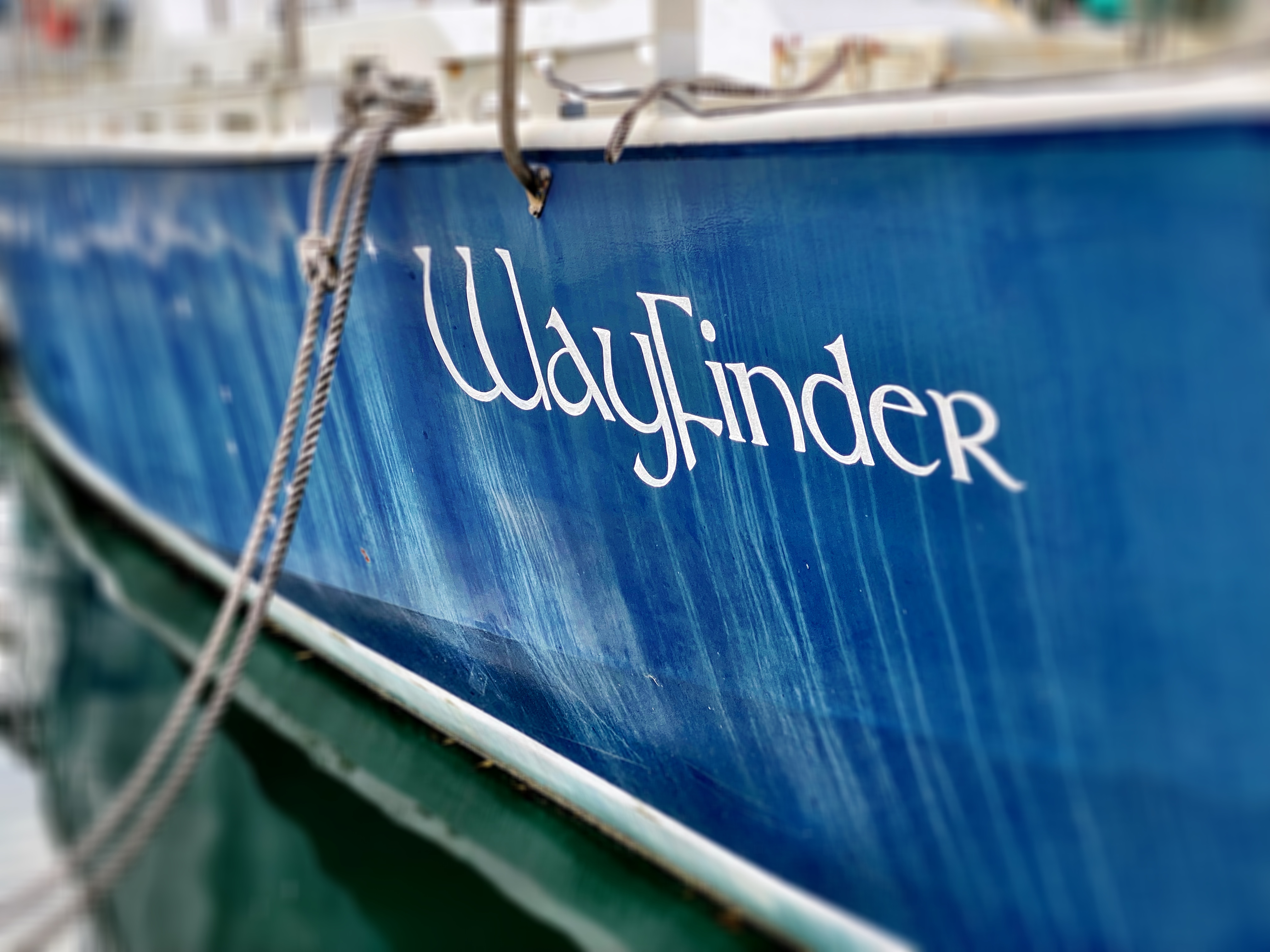 wayfinder - signage on side of a blue boat